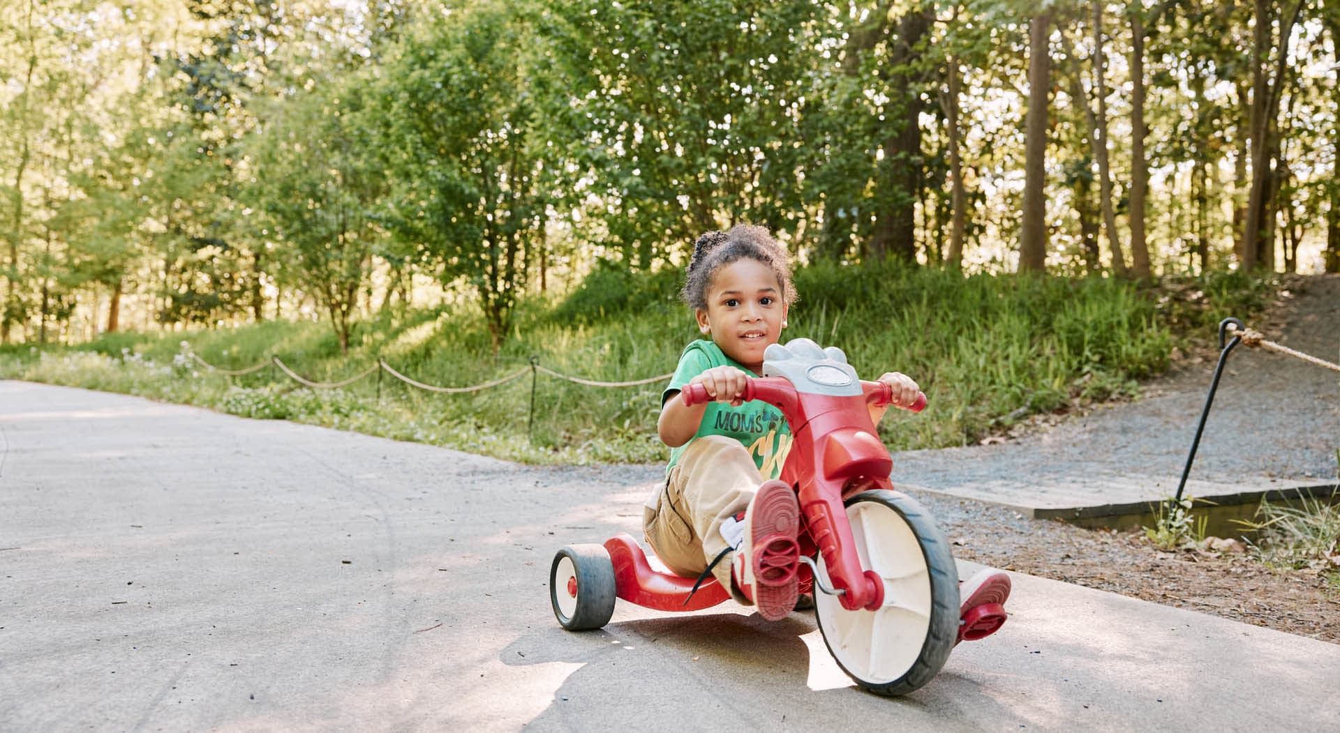 A young child rides a tricycle on the Beltline's Westside Trail. (Photo Credit: Erin Sintos)