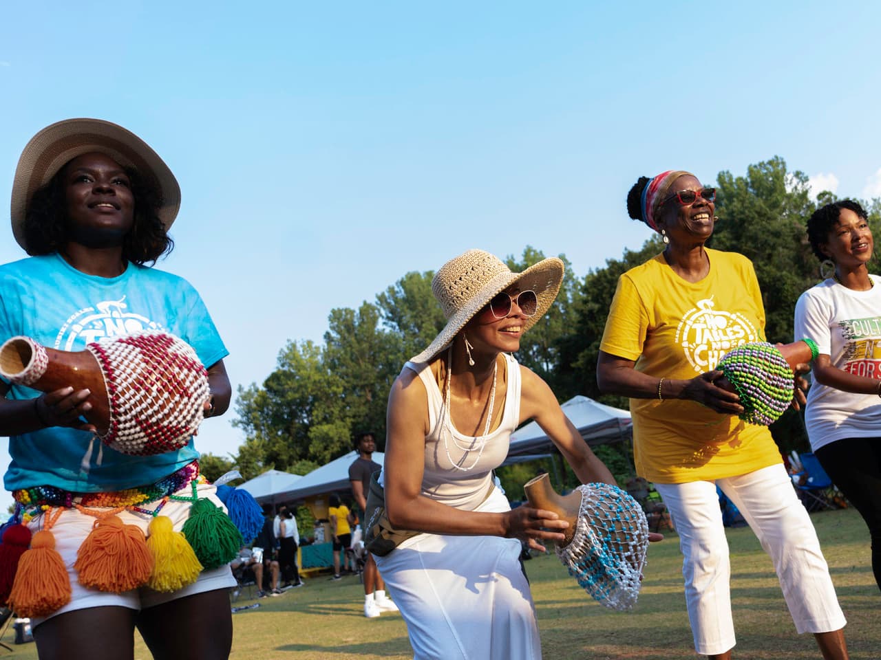 People stand with musical instruments.