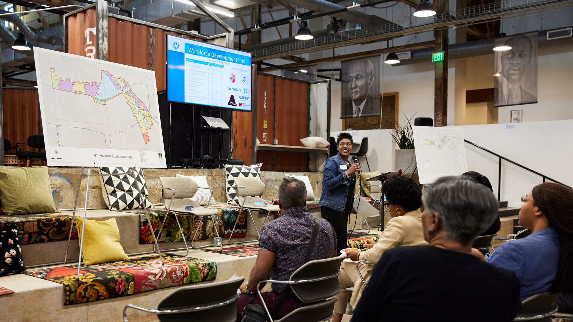 A person addresses a crowd during a community meeting.